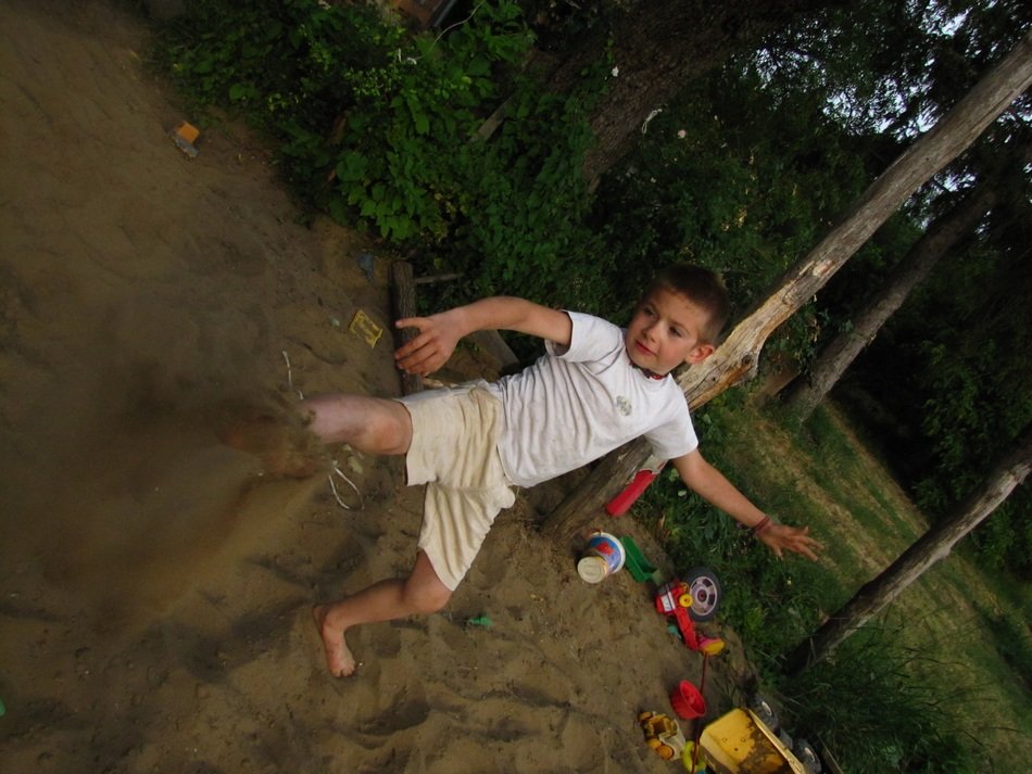 child throws sand