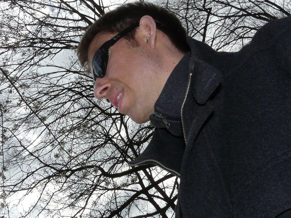 man in sunglasses on a background of an autumn tree