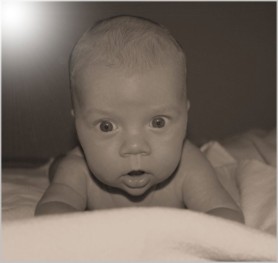 charming baby stares at the blanket