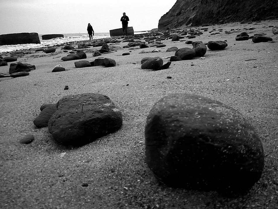 beach with large stones in black and white background