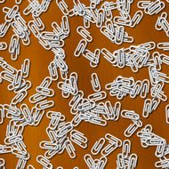 Many white paper clips on wood seamless pattern