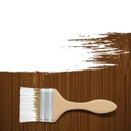 Paintbrush with white paint on a wooden surface