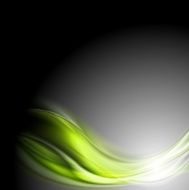 Green glowing waves on dark background