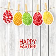 Paper Easter eggs on wooden background