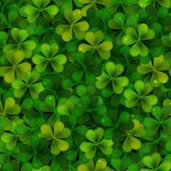 Seamless pattern with green realistic Saint Patricks day shamrock leaves