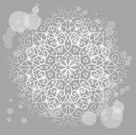 Abstract grey background with a round mandala ornament sparkles