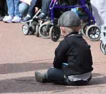 A little boy is sitting on the earth