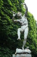 stone statue with flute in the park