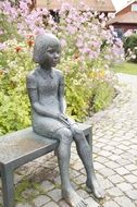 sculpture of a sitting girl