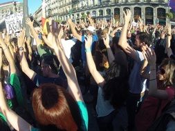 People with their hands up in the square of madrid
