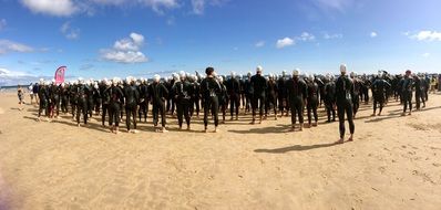 a crowd of people stands in the desert
