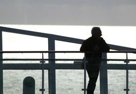 silhouette of a man looking at the sea