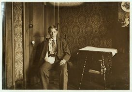 young boy with broken hand sitting at door, vintage