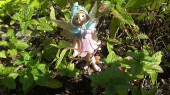 toy fairy on a green bush