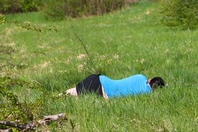 man sleeping in a green meadow