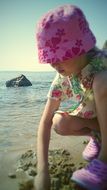Small girl on the beach in summer