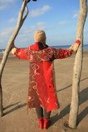 woman in red dress on the beach