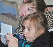 girl and boy play with game console