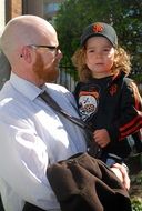 father holds baby in his arms