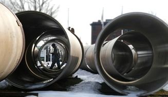 man is walking along the drain pipes