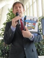 Lecturer with a microphone on a book presentation