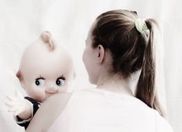 girl with doll in hands