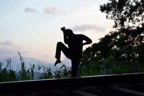 fighter engaged in thai boxing at sunset