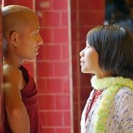 buddhist monk talking with asian girl, myanmar