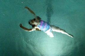 child girl swimming in pool