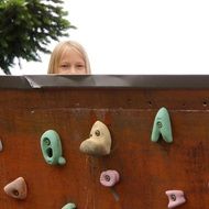 child behind a climbing wall