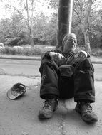 homeless man in the street in black and white image