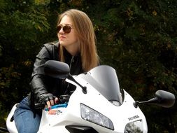 blonde girl on motorcycle wearing leather jacket