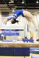 Woman performance of gymnastic with jumping backward