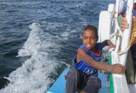 a boy rides a yacht on the nile