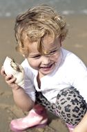 child with a seashell