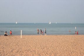 people on the beach near the sea