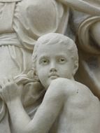 stone statue on the facade of the house