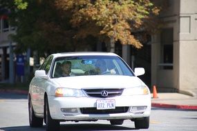 white sedan car on the street road