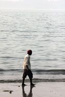 lonely man is walking on the beach