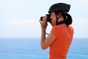 cyclist with a camera on the background of the sea