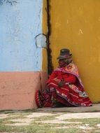 indigenous of Peru sits on the city street