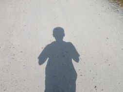 shadow of a man on the road