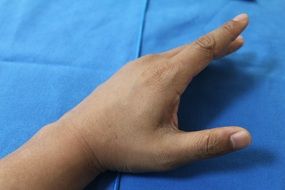 hand on blue fabric background