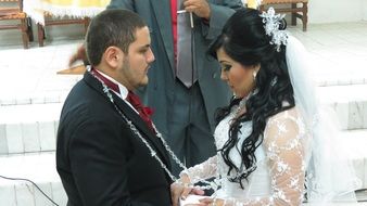 happy young wedding couple holding hands together