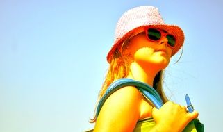 girl in sunglasses and straw hat