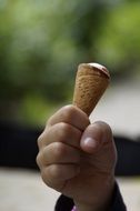 ice cream cone in a kid's hand