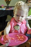 child near the plate with cake