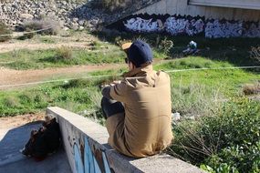 man sits on the concrete