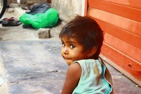 child in a poor neighborhood in india