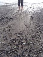 feet on the rocky beach